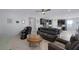 Inviting living room with leather seating, a ceiling fan, and an open layout connecting to the kitchen and dining area at 888 Cherry Glen Pl, Las Vegas, NV 89138