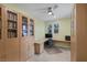 Well-lit office with built-in bookshelves, a large desk, and neutral decor, offering a functional and organized workspace at 888 Cherry Glen Pl, Las Vegas, NV 89138