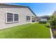Backyard featuring a hot tub, patio seating, artificial grass, and privacy wall at 8929 Cassia Winds St, Las Vegas, NV 89166