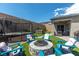 Backyard featuring a covered patio, in-ground hot tub, trampoline, and fire pit at 8929 Cassia Winds St, Las Vegas, NV 89166