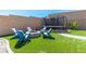 Landscaped backyard featuring a fire pit, trampoline, and artificial grass at 8929 Cassia Winds St, Las Vegas, NV 89166
