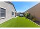 Backyard features hot tub, patio seating, and artificial grass at 8929 Cassia Winds St, Las Vegas, NV 89166