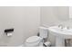 Half bath with pedestal sink, toilet and modern hardware at 8929 Cassia Winds St, Las Vegas, NV 89166