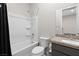 Clean bathroom with white tub, shower, toilet, and vanity with a marble countertop at 8929 Cassia Winds St, Las Vegas, NV 89166