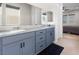 Bathroom featuring double sinks and granite countertop, plus open view to bedroom at 8929 Cassia Winds St, Las Vegas, NV 89166