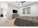 Comfortable bedroom with a large bed, dresser with TV, and two windows at 8929 Cassia Winds St, Las Vegas, NV 89166