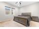 Neutral bedroom with large bed, two windows, and matching nightstands at 8929 Cassia Winds St, Las Vegas, NV 89166