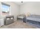 Cozy Bedroom features two cribs, a changing table, and a bright window at 8929 Cassia Winds St, Las Vegas, NV 89166