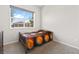 Cozy bedroom featuring a metal frame bed, large window, and neutral carpet at 8929 Cassia Winds St, Las Vegas, NV 89166