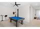 Entertaining game room with pool table, a dark ceiling fan and stylish decor at 8929 Cassia Winds St, Las Vegas, NV 89166