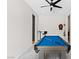 Bright game room featuring a pool table, ceiling fan, bar-height table, and dart board on the wall at 8929 Cassia Winds St, Las Vegas, NV 89166
