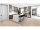 Spacious kitchen with island seating, gray cabinets, stainless appliances, and ample counter space at 8929 Cassia Winds St, Las Vegas, NV 89166