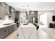 Modern kitchen features gray cabinets, stainless steel appliances, and a large white quartz island at 8929 Cassia Winds St, Las Vegas, NV 89166
