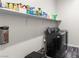 Laundry room with modern washer and dryer, plus overhead storage shelving at 8929 Cassia Winds St, Las Vegas, NV 89166