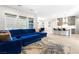 Open living space with large blue sectional sofa adjacent to kitchen at 8929 Cassia Winds St, Las Vegas, NV 89166