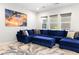 Relax in this living room with the plush blue sofa and unique wall art at 8929 Cassia Winds St, Las Vegas, NV 89166