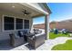Relaxing covered patio with outdoor seating, a fire pit, and a grill, great for entertaining guests at 8929 Cassia Winds St, Las Vegas, NV 89166