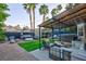 Landscaped backyard with covered patio, outdoor seating, lush greenery and a relaxing hot tub at 9013 Cypress Point Way, Las Vegas, NV 89117