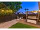 Inviting backyard seating area with string lights, comfortable seating, and a charming swing at 9013 Cypress Point Way, Las Vegas, NV 89117