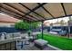 Outdoor space complete with lounge seating, artificial grass, and shaded pergola at 9013 Cypress Point Way, Las Vegas, NV 89117