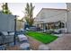 Large backyard with artificial grass, spa, and a covered seating area is perfect for relaxing at 9013 Cypress Point Way, Las Vegas, NV 89117