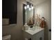 Stylish bathroom with a modern mirror, sleek vanity, and decorative floral arrangements at 9013 Cypress Point Way, Las Vegas, NV 89117