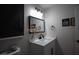 Bathroom featuring a single sink vanity with dark hardware and accent decorations at 9013 Cypress Point Way, Las Vegas, NV 89117