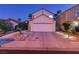 Attractive home exterior with a two-car garage, mature landscaping, and great curb appeal at 9013 Cypress Point Way, Las Vegas, NV 89117