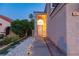 Well-lit home exterior with beautiful desert landscaping and path to front door at 9013 Cypress Point Way, Las Vegas, NV 89117