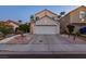 Traditional two-story home with a driveway, two car garage and desert landscaping at 9013 Cypress Point Way, Las Vegas, NV 89117