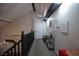 Hallway with modern black railing, accent paintings, and decorative furnishings on display at 9013 Cypress Point Way, Las Vegas, NV 89117