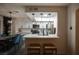 Kitchen with a breakfast bar looking into an eat-in kitchen with stainless steel appliances at 9013 Cypress Point Way, Las Vegas, NV 89117