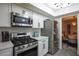 Updated kitchen with stainless steel appliances and sleek white cabinets at 9013 Cypress Point Way, Las Vegas, NV 89117