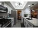 Modern kitchen with white cabinets, stainless steel appliances, quartz countertops and an open layout at 9013 Cypress Point Way, Las Vegas, NV 89117