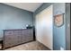 Carpeted bedroom with a large dresser and closet doors under blue-painted walls at 9065 Adorable Ave, Las Vegas, NV 89149