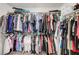 Walk-in closet filled with various clothes hanging on rods and stacked on shelves at 9065 Adorable Ave, Las Vegas, NV 89149