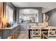 Dining room with an open-concept view to a modern kitchen, perfect for gatherings at 9065 Adorable Ave, Las Vegas, NV 89149