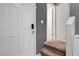 Front door entryway with carpeted stairs and neutral decor at 9065 Adorable Ave, Las Vegas, NV 89149
