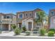 Charming two-story home featuring desert landscaping, a private entry porch with chairs, and an attached one car garage at 9065 Adorable Ave, Las Vegas, NV 89149