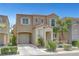 Charming two-story home featuring desert landscaping, a private entry porch, and an attached one car garage at 9065 Adorable Ave, Las Vegas, NV 89149