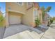 Charming two-story home featuring desert landscaping, a private entry porch, and an attached one car garage and driveway at 9065 Adorable Ave, Las Vegas, NV 89149