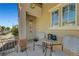 Inviting front porch area with seating and desert landscaping offering a relaxing outdoor space at 9065 Adorable Ave, Las Vegas, NV 89149