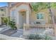 Inviting front porch area with seating, desert landscaping, and a secure front door for added privacy at 9065 Adorable Ave, Las Vegas, NV 89149