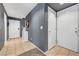Inviting hallway featuring neutral tile flooring, modern gray walls, and a white storage cabinet at 9065 Adorable Ave, Las Vegas, NV 89149