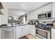 Well-lit kitchen featuring stainless steel appliances and white cabinetry at 9065 Adorable Ave, Las Vegas, NV 89149