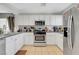 Well-maintained kitchen featuring stainless steel appliances, white cabinets, and tile flooring at 9065 Adorable Ave, Las Vegas, NV 89149