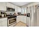 Well-maintained kitchen featuring stainless steel appliances, white cabinets, and ample counter space at 9065 Adorable Ave, Las Vegas, NV 89149