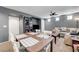Spacious living room and dining area with a TV, ceiling fan, and modern furnishings at 9065 Adorable Ave, Las Vegas, NV 89149