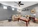 Comfortable living room with a large sectional sofa, modern ceiling fan, and stylish decor at 9065 Adorable Ave, Las Vegas, NV 89149