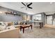 Open-concept living area featuring a sofa, shelving decor, and dining area with a kitchen view at 9065 Adorable Ave, Las Vegas, NV 89149